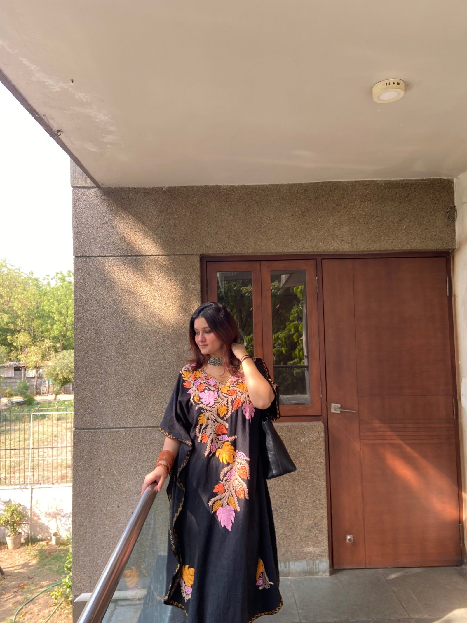 model wearing black crush cotton kaftan dress